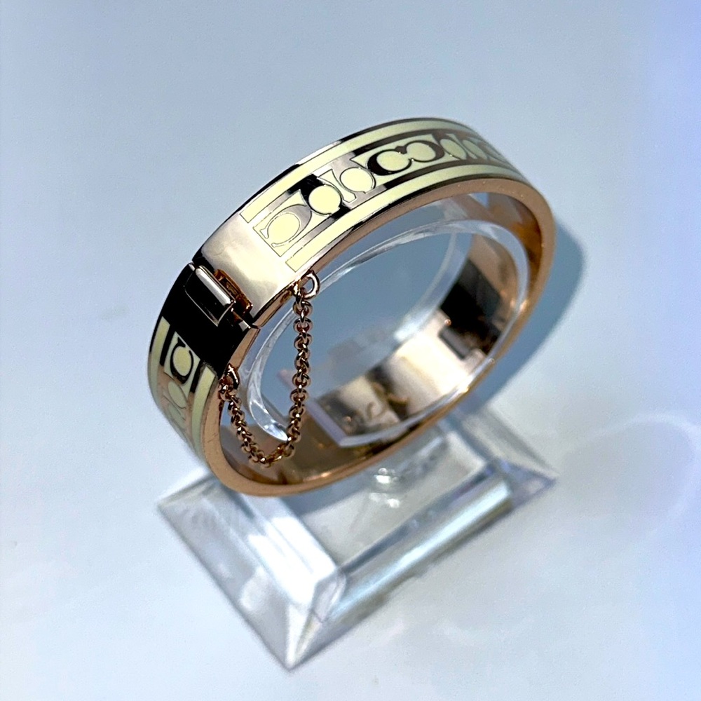 Signature Enamel Coach Bangle Bracelet. Rose Tone & Cream. W/Safety Chain.